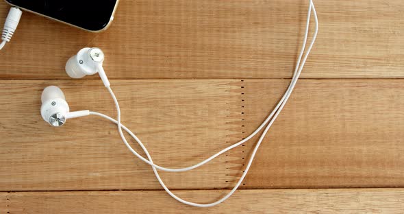 Close-up of mobile phone with headphones