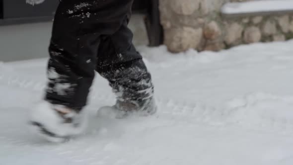 Winter Vacation Game Family Concept  Slow Motion Close Up Baby Walk Through Deep Snow