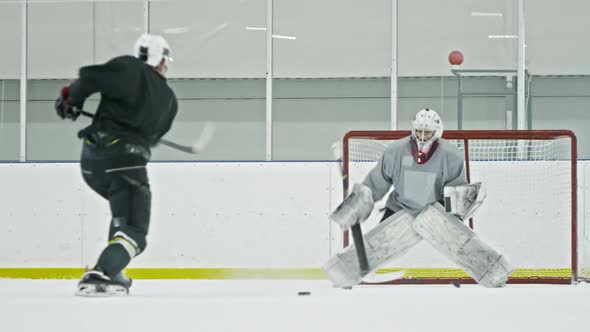 Hockey Forward and Goalie Practicing