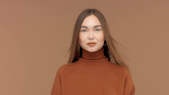 Monochrome Brown Look Caucasian Woman in Studio Portrait with Hair Blowing