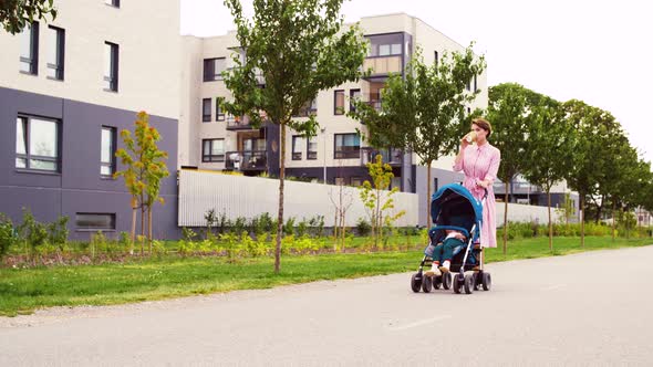 Mother with Baby in Stroller and Coffee in City