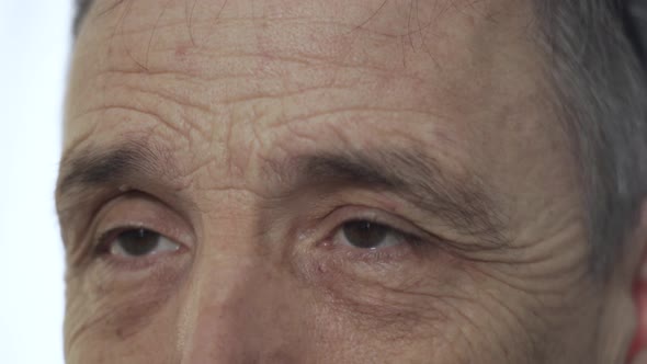 Emotional Portrait of an Elderly Person's Eyes Closeup White Background