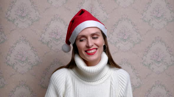 Young Positive Woman with Christmas Cap.