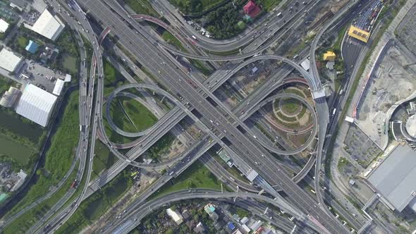 Aerial View of Highway Road Interchange with Busy Urban Traffic Speeding on Road