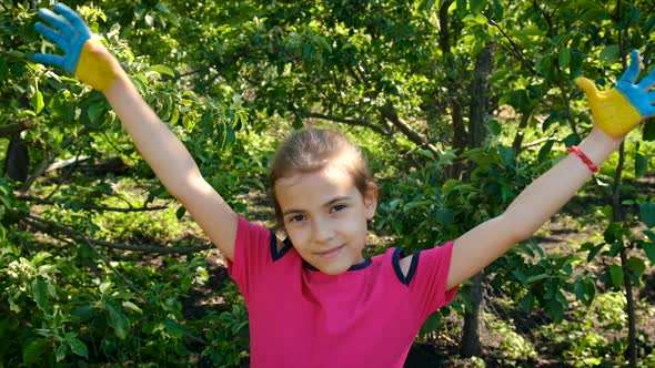 The Ukrainian Flag is Drawn on the Child Hands