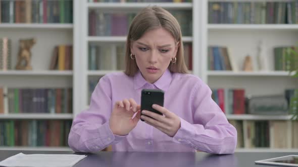 Upset Woman Reacting to Loss on Smartphone