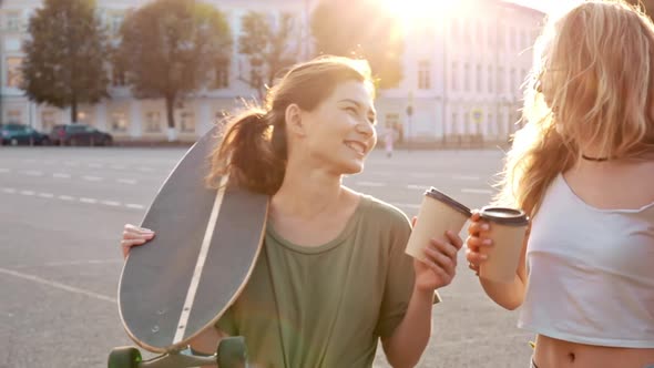 Two Fashion Hipster Girls at Outdoors Summer Party Pretty Teenage Friends with Skateboard in