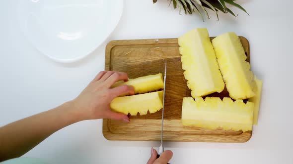 View of slices of fresh pineapple. Sliced pineapple on desk with knife isolated on white background