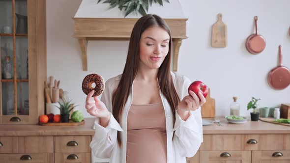 Pregnant Woman Hesitates Choosing Between Donut and Apple