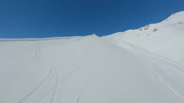 Shooting From Above Extreme Sportsman Riding Snowboard Downhill Snowy Mountain Peak Sport Activity