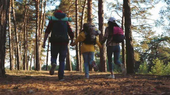 Happy Family Hiking Through a Forest