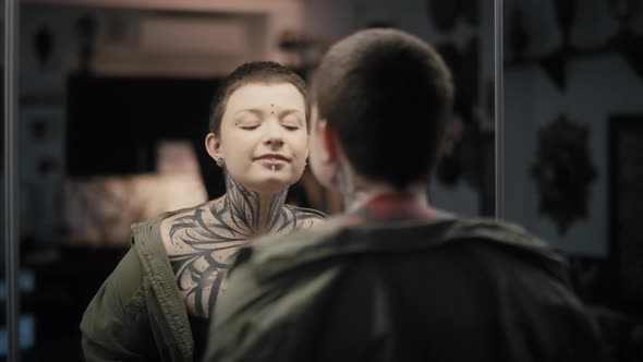 Young adult caucasian woman looking at herself in the mirror. Shot with RED helium camera in 8K.