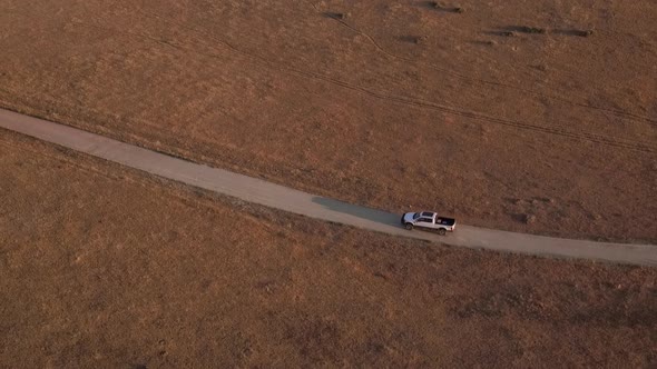 drone shot of a truck on a dirt road