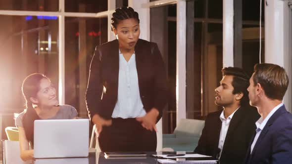 Businesswoman leading meeting in conference room