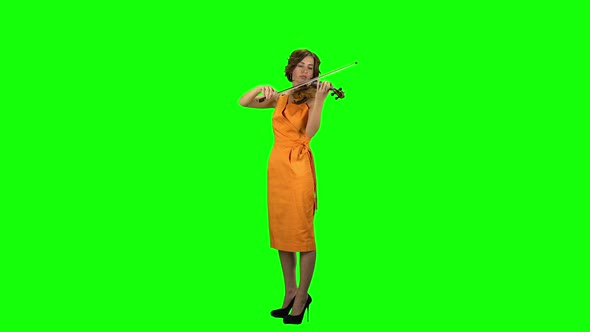 Woman Plays a Wooden Violin. Green Screen