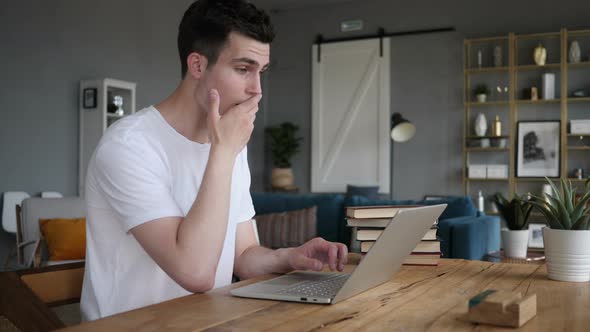 Shocked, Stunned Man Wondering and Working on Laptop