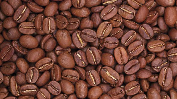 Spinning roasted Arabica coffee beans background