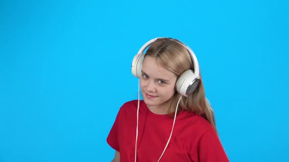 Girl Listening To Music in Big White Headphones, Singing and Dancing. Slow Motion