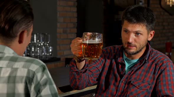 Mature Bearded Man Talking To His Friend While Drinking Beer at the Pub 1080p