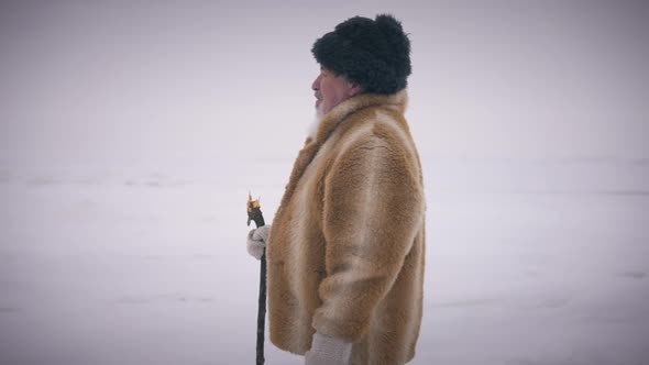 Medium Shot Side View Old Man Walking at Background of Winter Landscape Leaving in Slow Motion