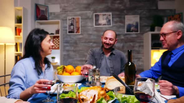 Zoom in Shot of Family Clinking Glasses of Red Wine