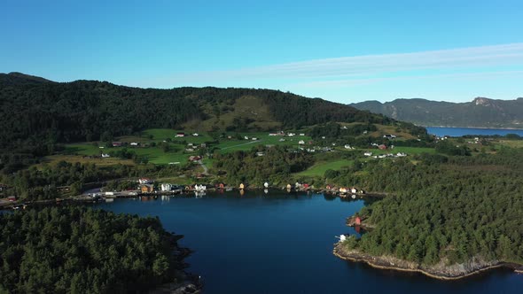 Beautiful early morning clip from Ubjoa Norway - Idyllic bay and local community aerial during sunri