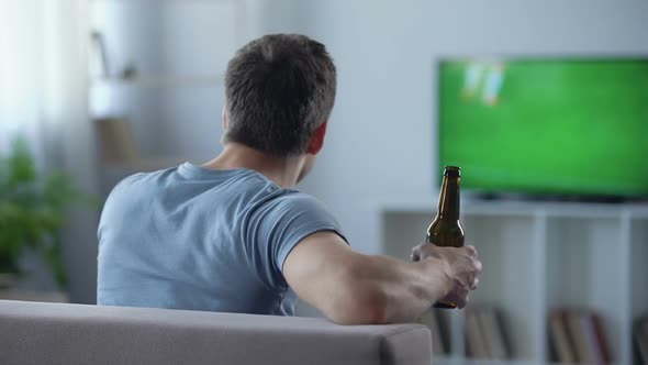 Male Supporter Watching Football Drinking Beer, Disappointed With Tie in Match