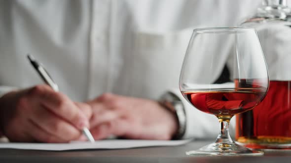 Businessman Drinking Brandy or Whiskey Closeup