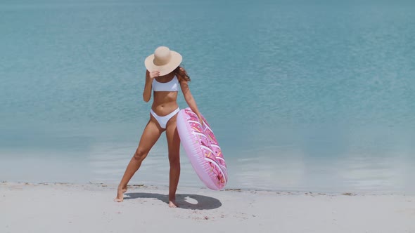 Woman on the Beach with a Rubber Ring.