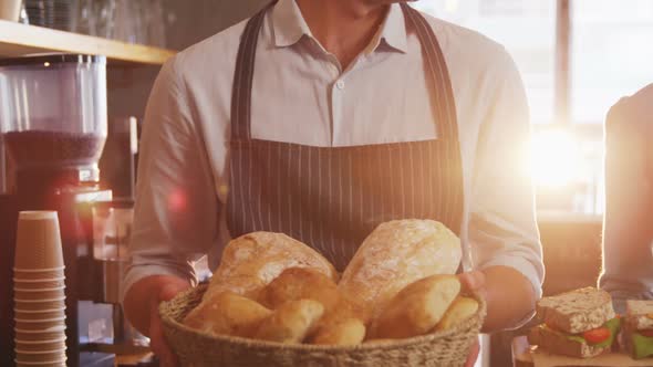 Waiter and waitress holding buns and sandwiches