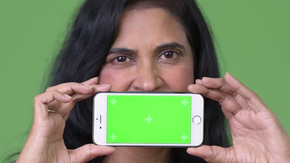 Close Up Shot of Mature Beautiful Indian Woman Showing Phone