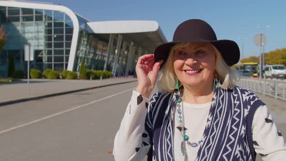 Portrait of Senior Pensioner Tourist Grandmother Stay Near Airport Hall Waiting for Plane Travel