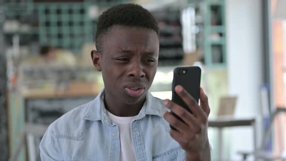 African Man Reacting to Failure on Smartphone