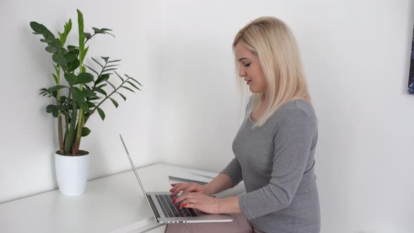 Woman Working From Home Having Group Videoconference On Laptop