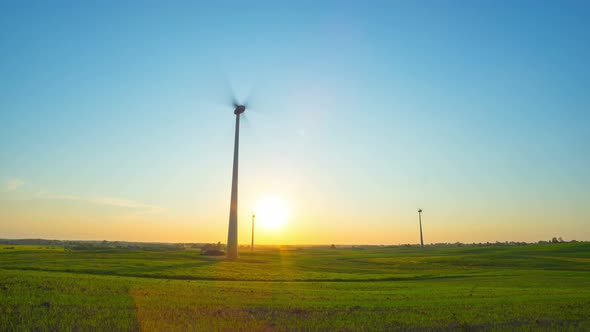Wind Turbines in the Field and Sunset