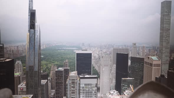 Boy Looking Through Rooftop Railings To New York Skyscrapers