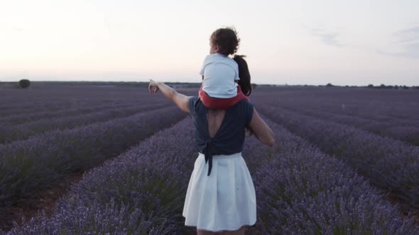 Woman and little child together in lavender field