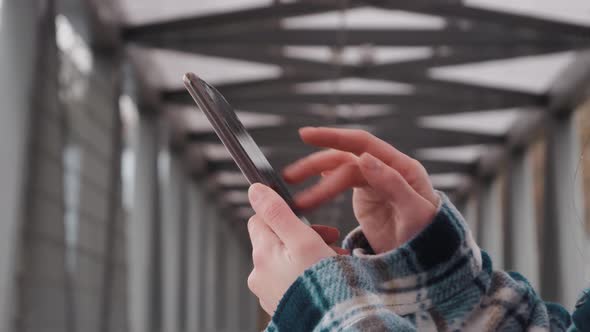 Side view. Hand of girl using smartphone in office, typing message. Close up of young women hand. Be