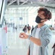 Asian male and female wearing protective face mask in airport terminal. - VideoHive Item for Sale