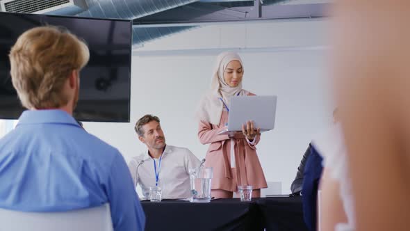 Speaker addressing the audience at a business conference