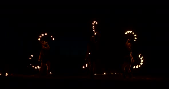 Slow Motion Professional Fire Performance Three Women with Torches and a Man with Flamethrowers