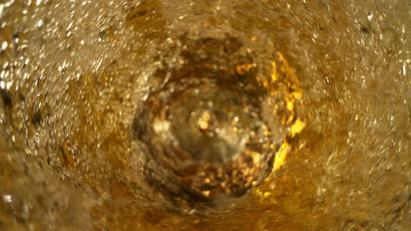 Super Slow Motion Shot of Fresh Beer Whirling in Glass Bottle at 1000Fps alt