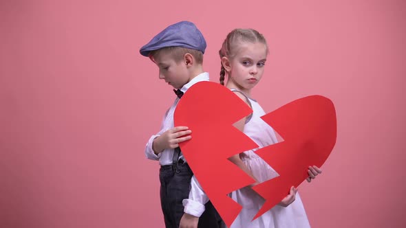 Sad Little Couple Holding Broken Pieces of Red Heart, Quarrelling, Brake Up