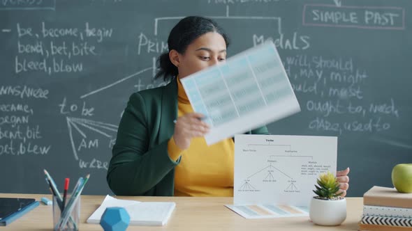 African American Lady Teaching English Giving Online Lecture Indoors in Classroom with Chalk Board alt