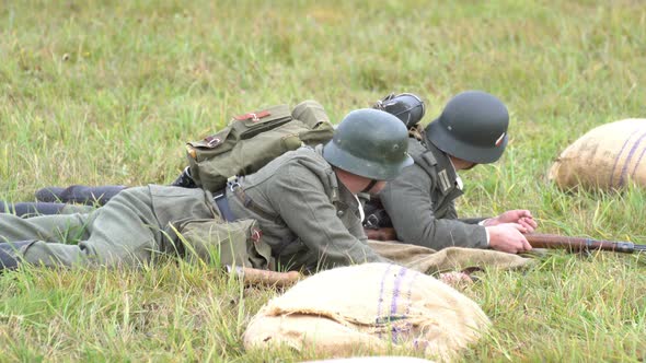 Soldiers lie on the ground