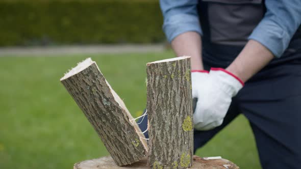 Caucasian Lumberjack Chopping Wood for Winter with an Axe