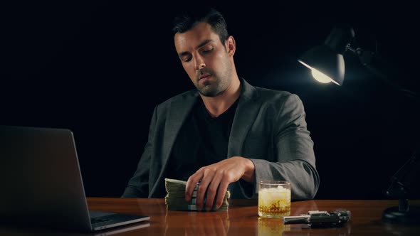 Handsome man plays with a stack of cash
