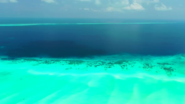 Wide angle above abstract shot of a summer white paradise sand beach and aqua blue water background 