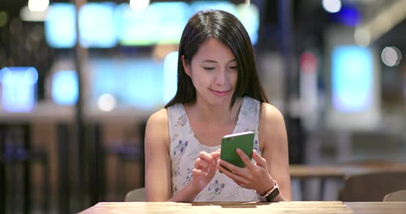 Woman Use of Mobile Phone Inside Restaurant