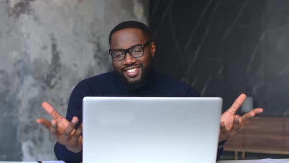Black Businessman Making Video Call Looking at Laptop Screen